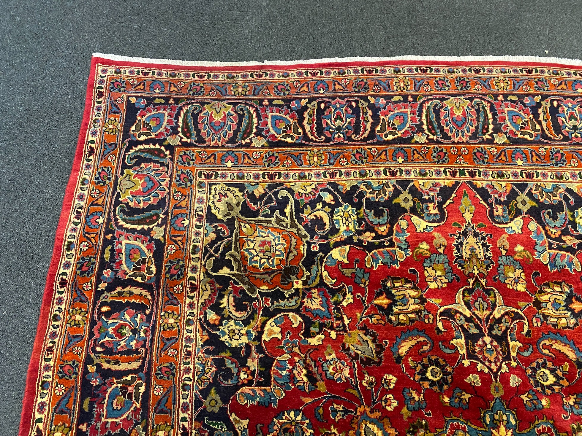 A Kashan claret ground carpet, 375cm x 250cm